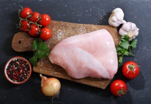 fresh turkey meat with ingredients for cooking, top view