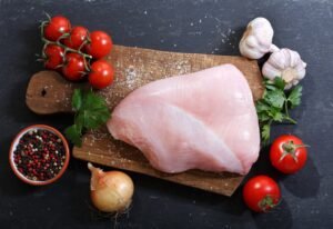 fresh turkey meat with ingredients for cooking, top view